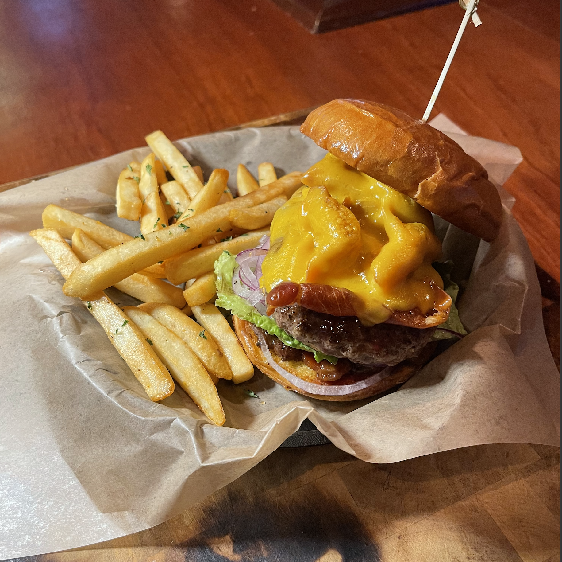 a sandwich sitting on top of a pile of fries