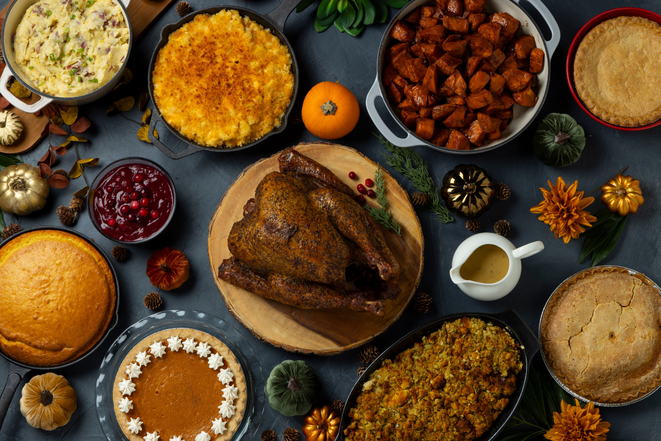Smoked turkey Thanksgiving spread with sides and pies