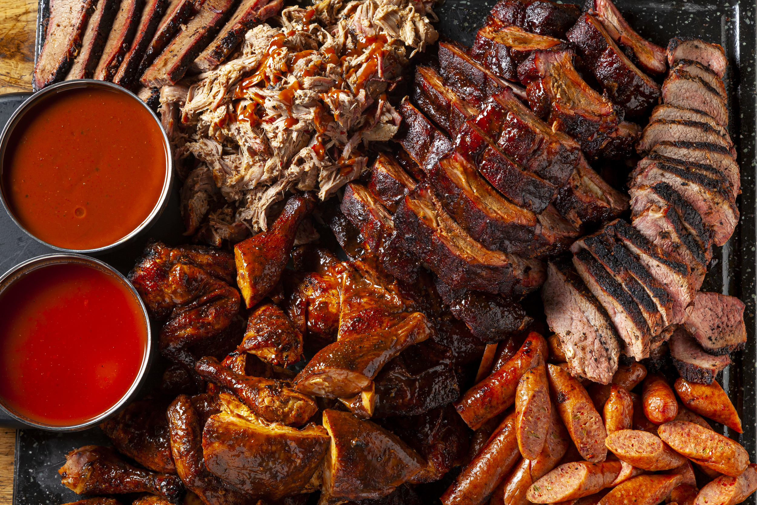 Bad to the Bone BBQ catering spread — smoked meats, ribs, and sides