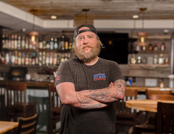 a man standing in front of a bar