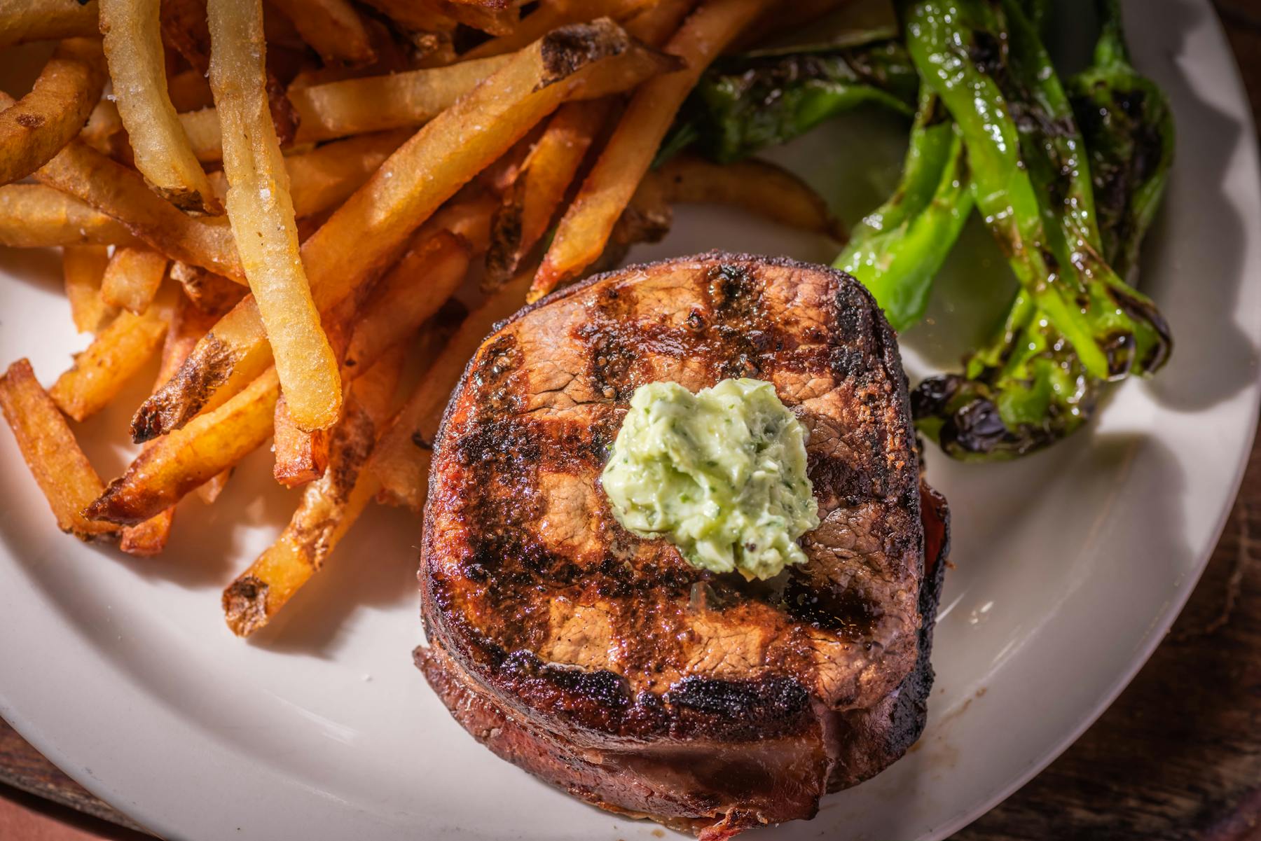 a plate of food that is on the side of fries