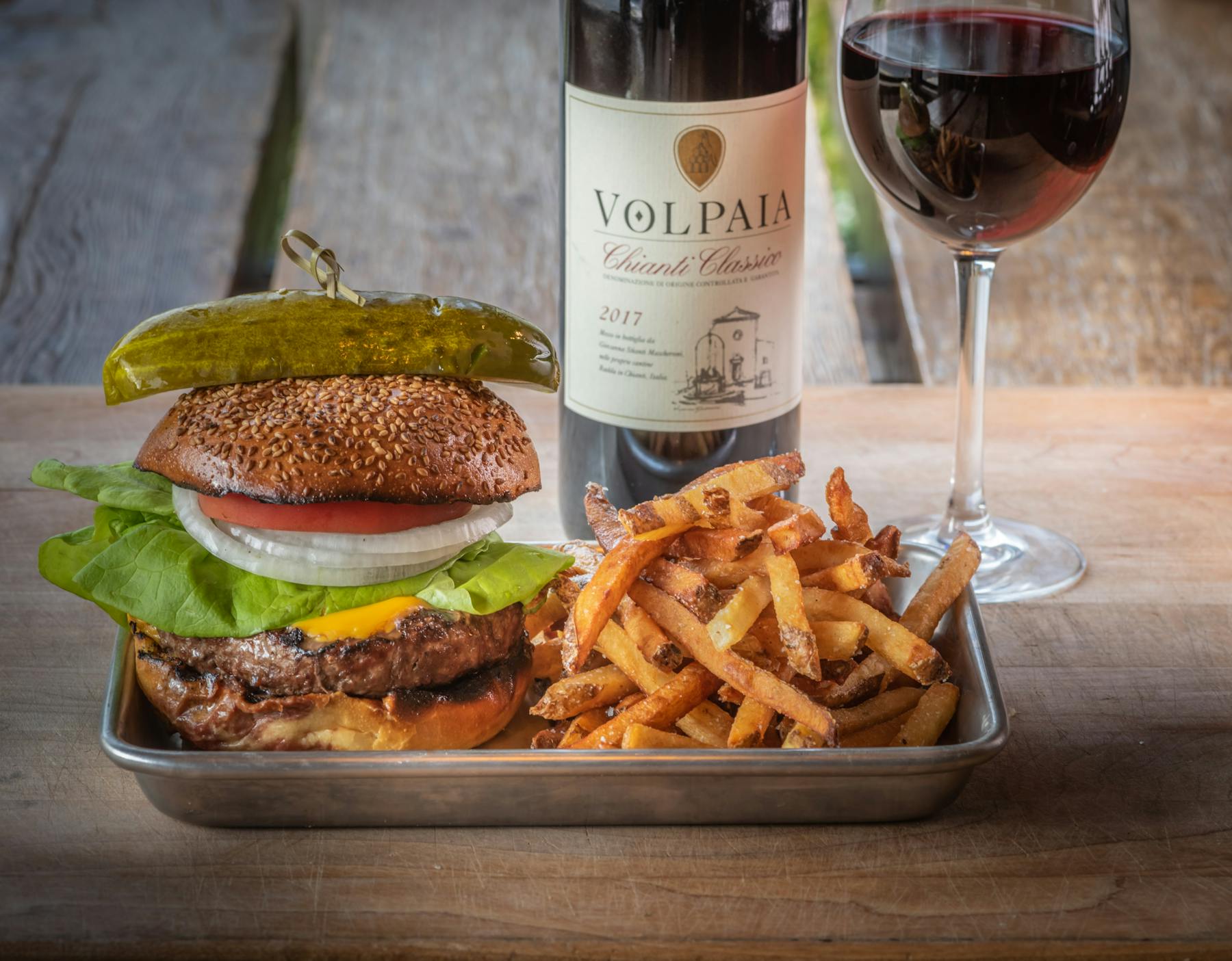 a plate of food and a bottle of wine on a table