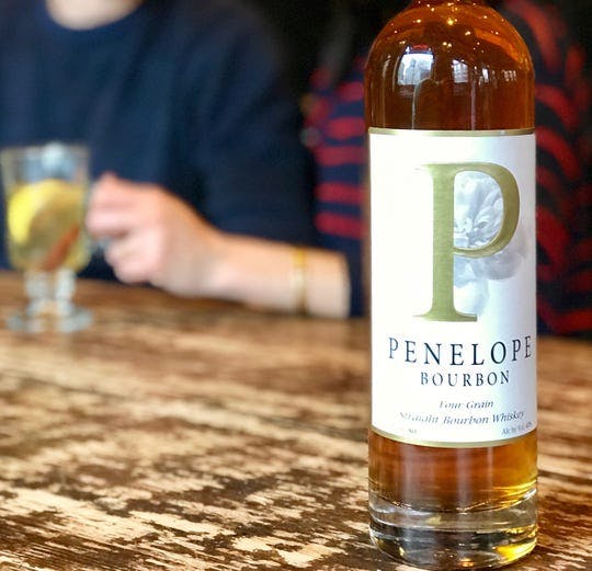 a person holding a bottle of wine