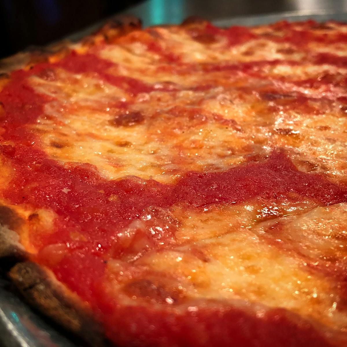 a close up of a pepperoni pizza sitting on top of a pan