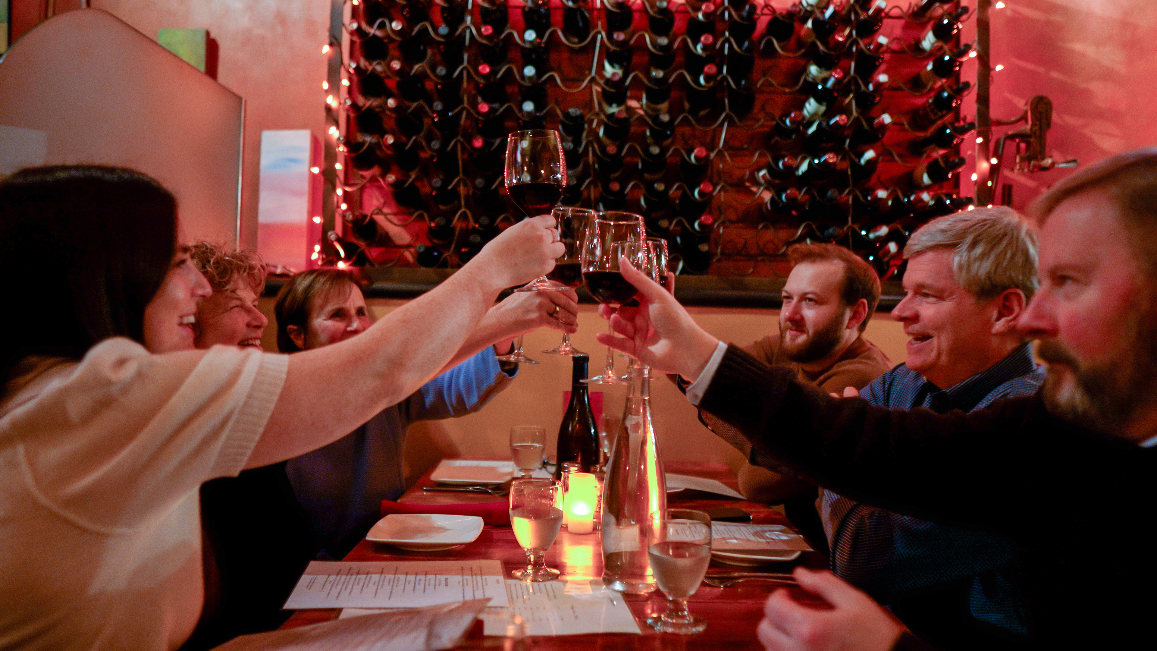 Mikhail Glinka et al. sitting at a table with wine glasses