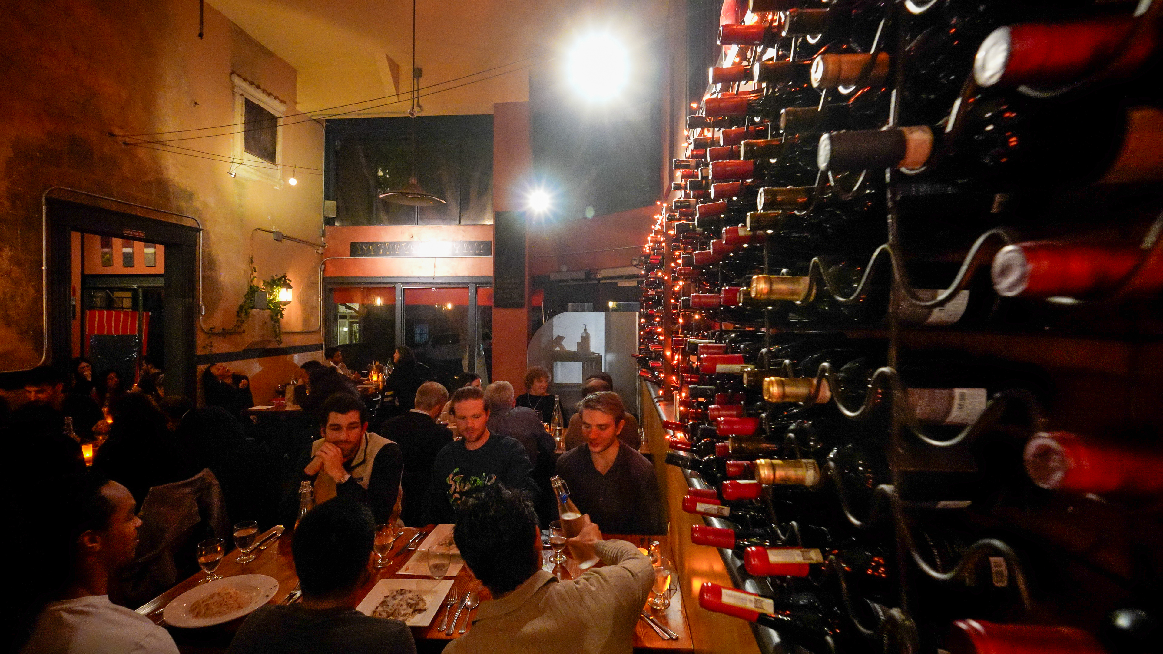 a group of people sitting at a table with wine glasses