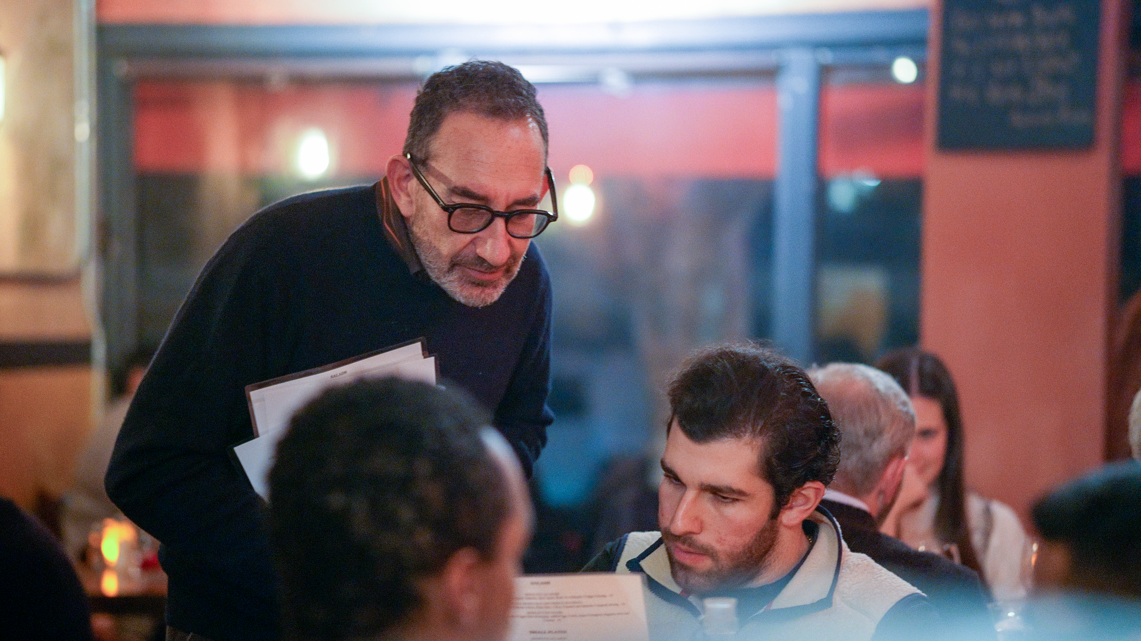 a man in glasses looking at the camera