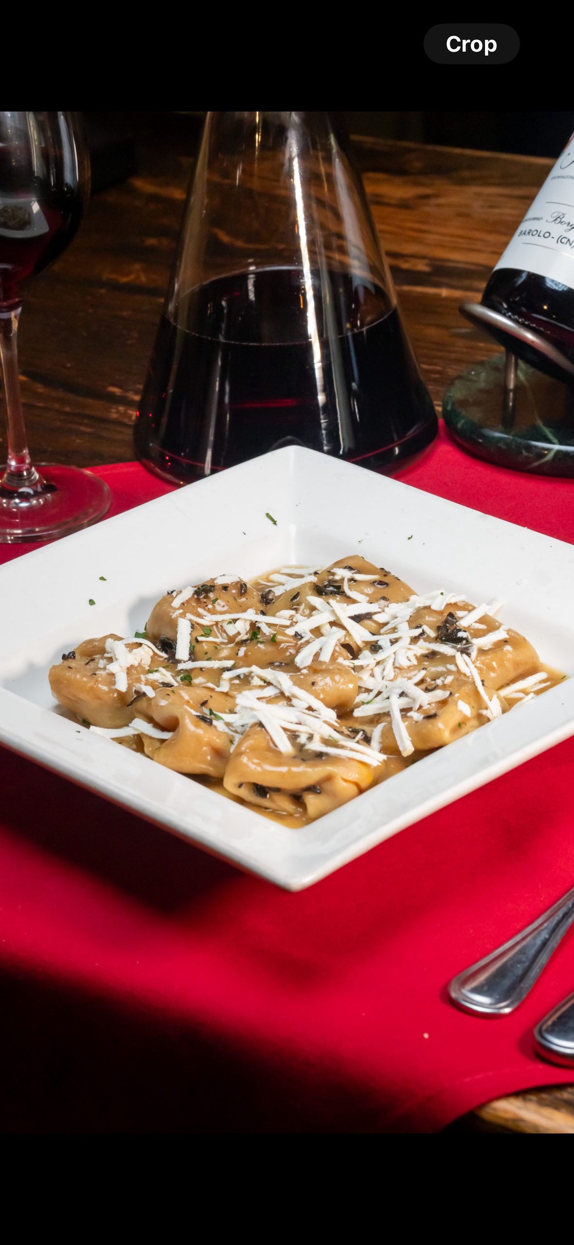 a plate of food and a bottle of wine on a table