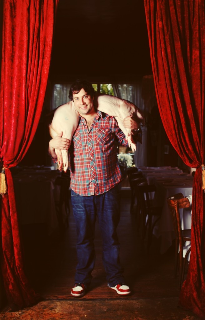 a person in a red dress standing in front of a curtain