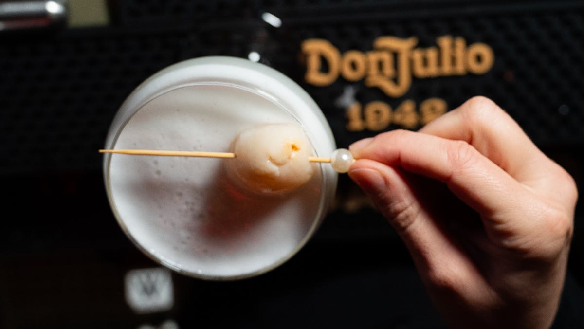 a hand holding a cup