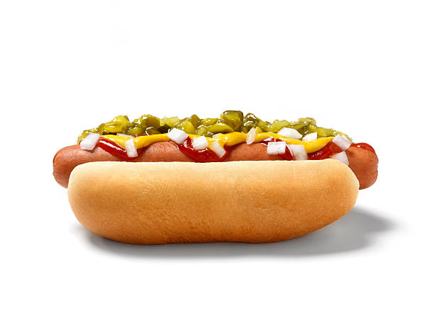 a hot dog on a bun covered in toppings
