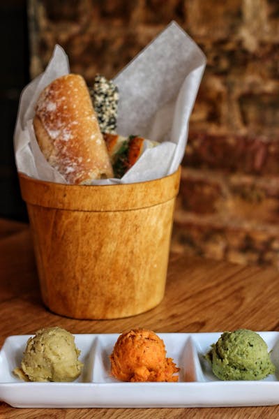 Homemade bread basket with homemade hummus trio