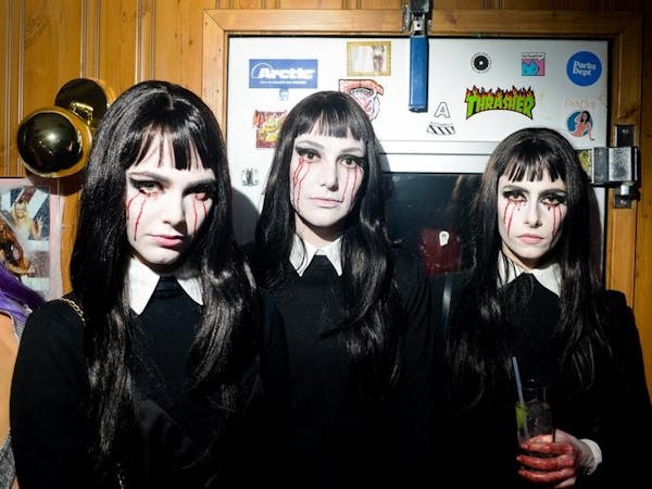 Three young women in a halloween goth getup