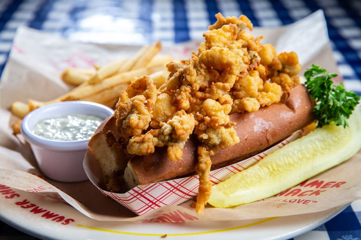 a hot dog with fried shrimps