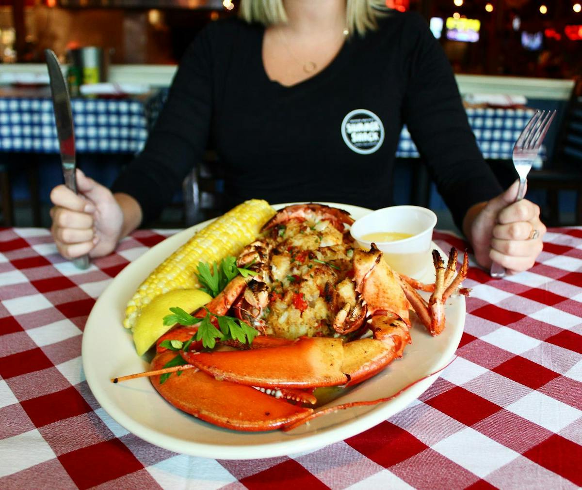 a person sitting at a table with a plate of food