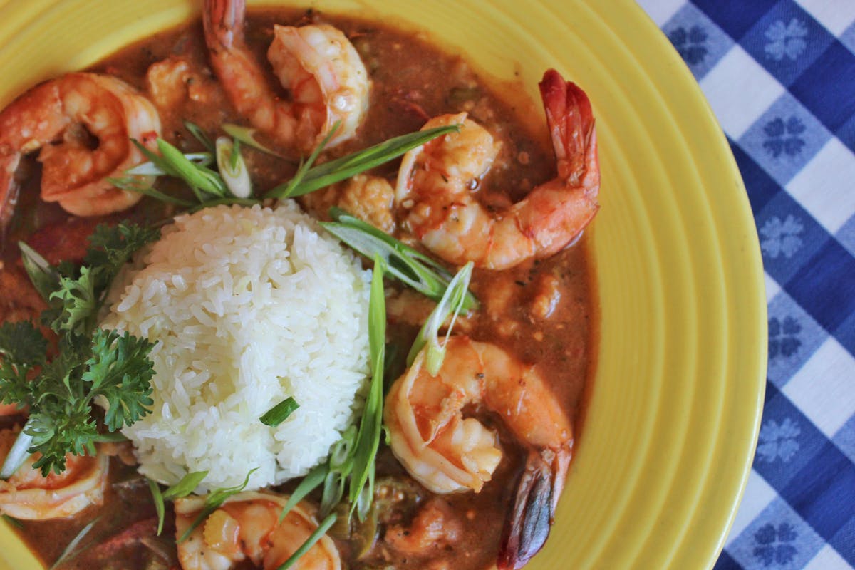 a plate of food with rice, shrimp, and vegetables