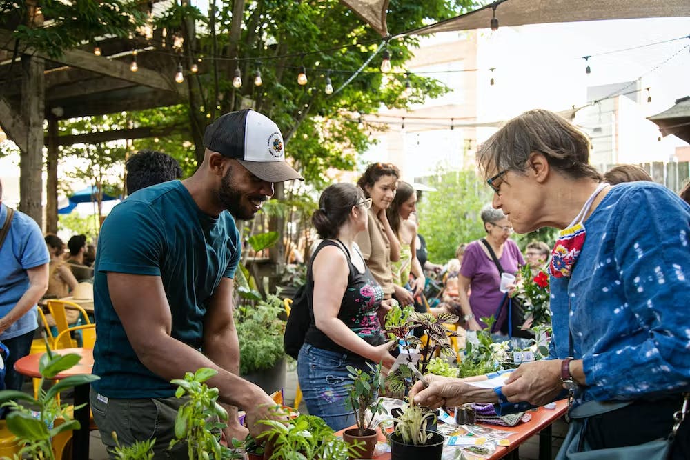 a group of people standing around a table