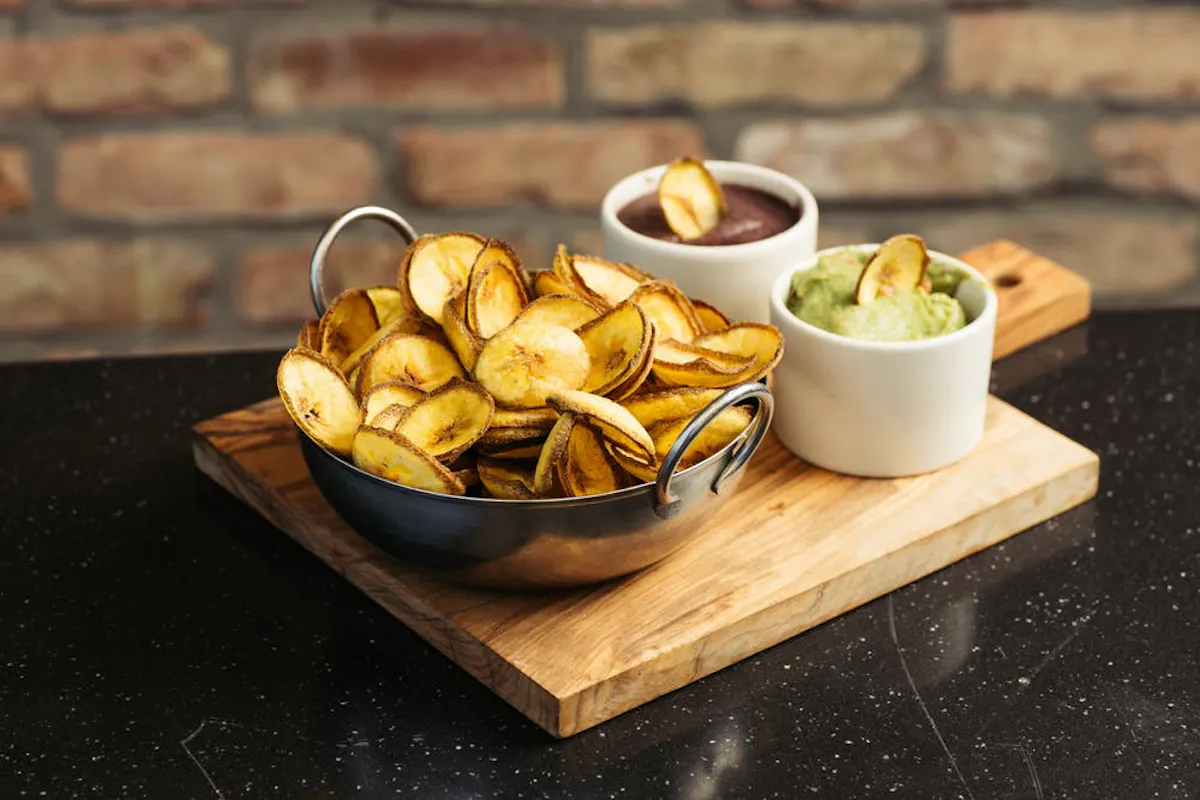 a bowl of fruit sitting on top of a wooden table