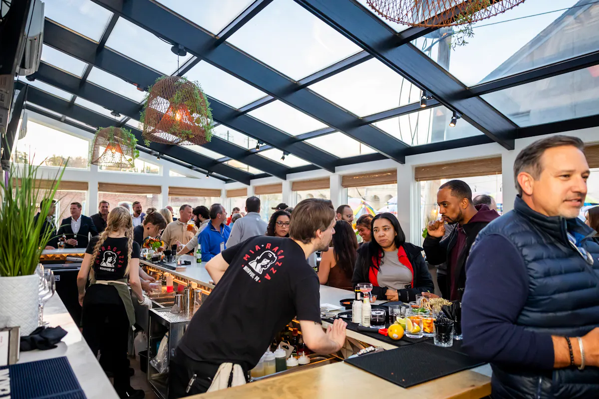 a group of people standing around a table