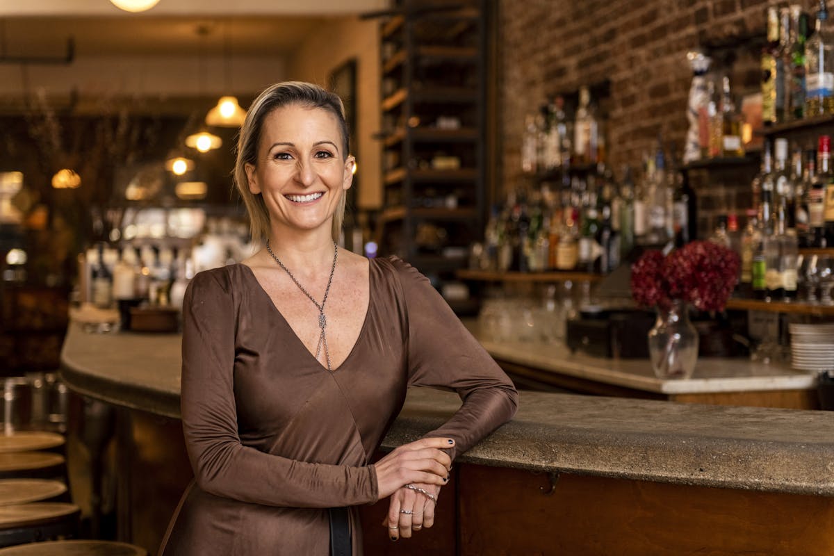 a woman standing at a bar