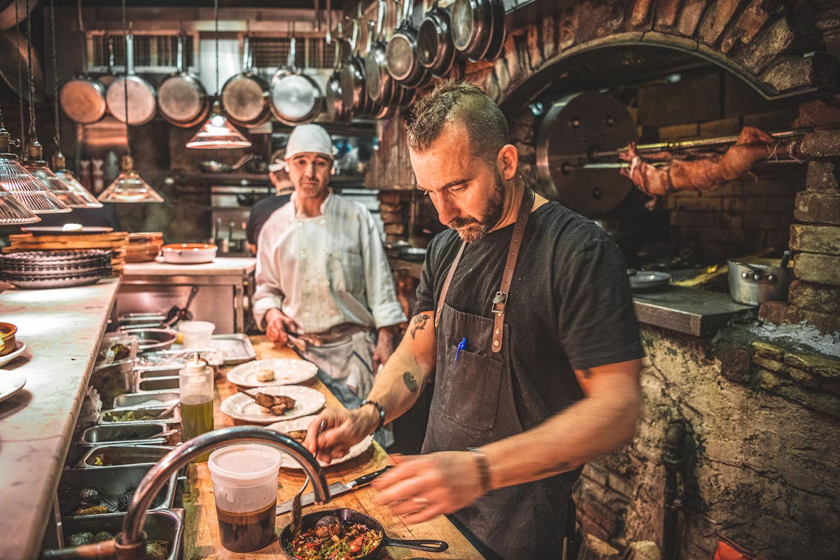 a man cooking in a kitchen preparing food