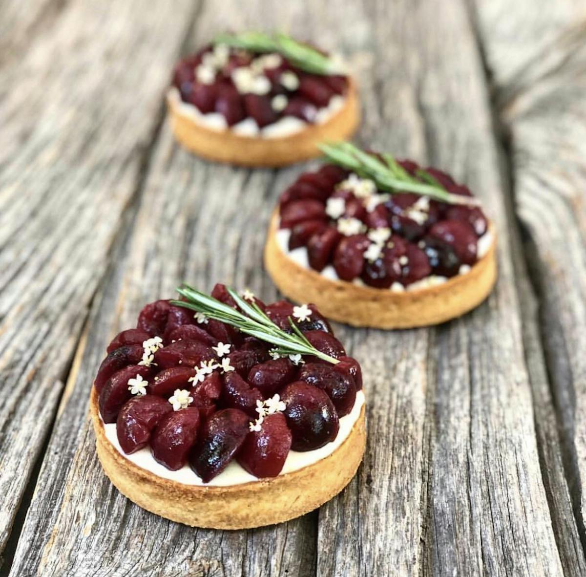 tarts with fruit on a wooden table