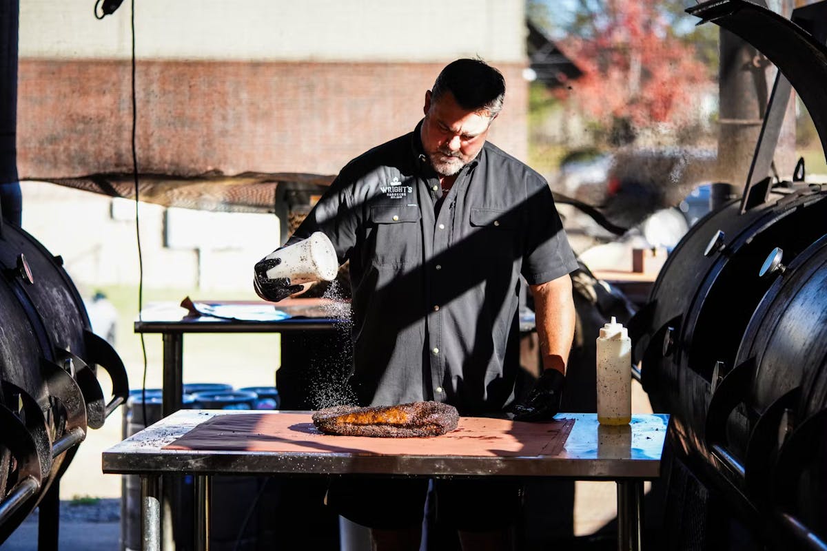 a man standing in front of a table
