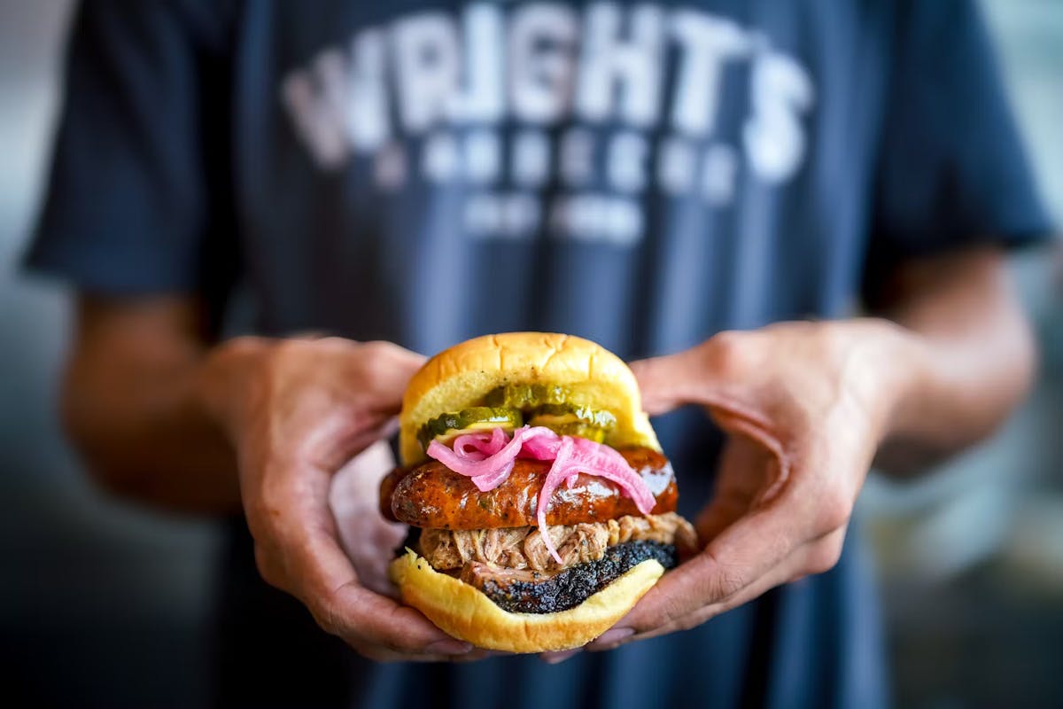 a close up of a person holding a hot dog