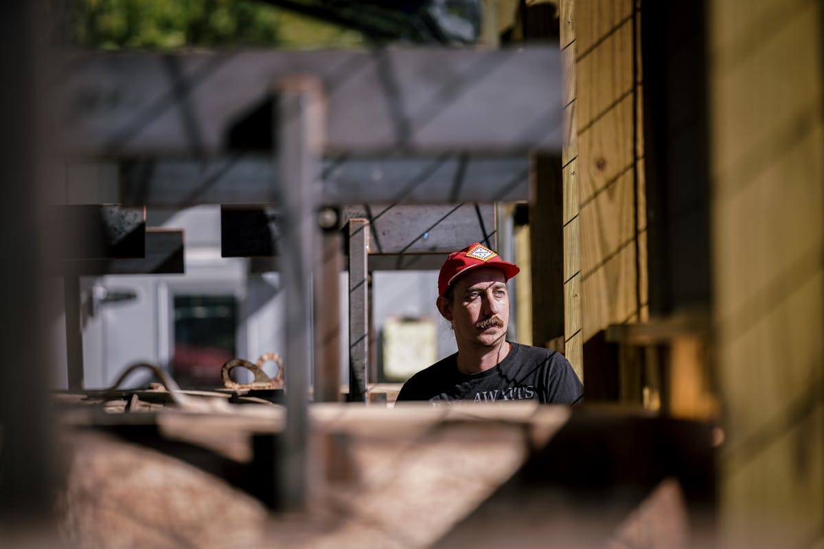 a man sitting in front of a building