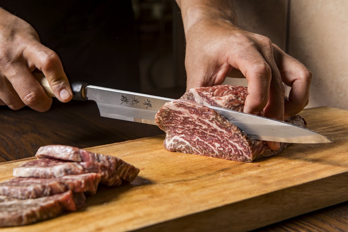a wooden cutting board with a knife