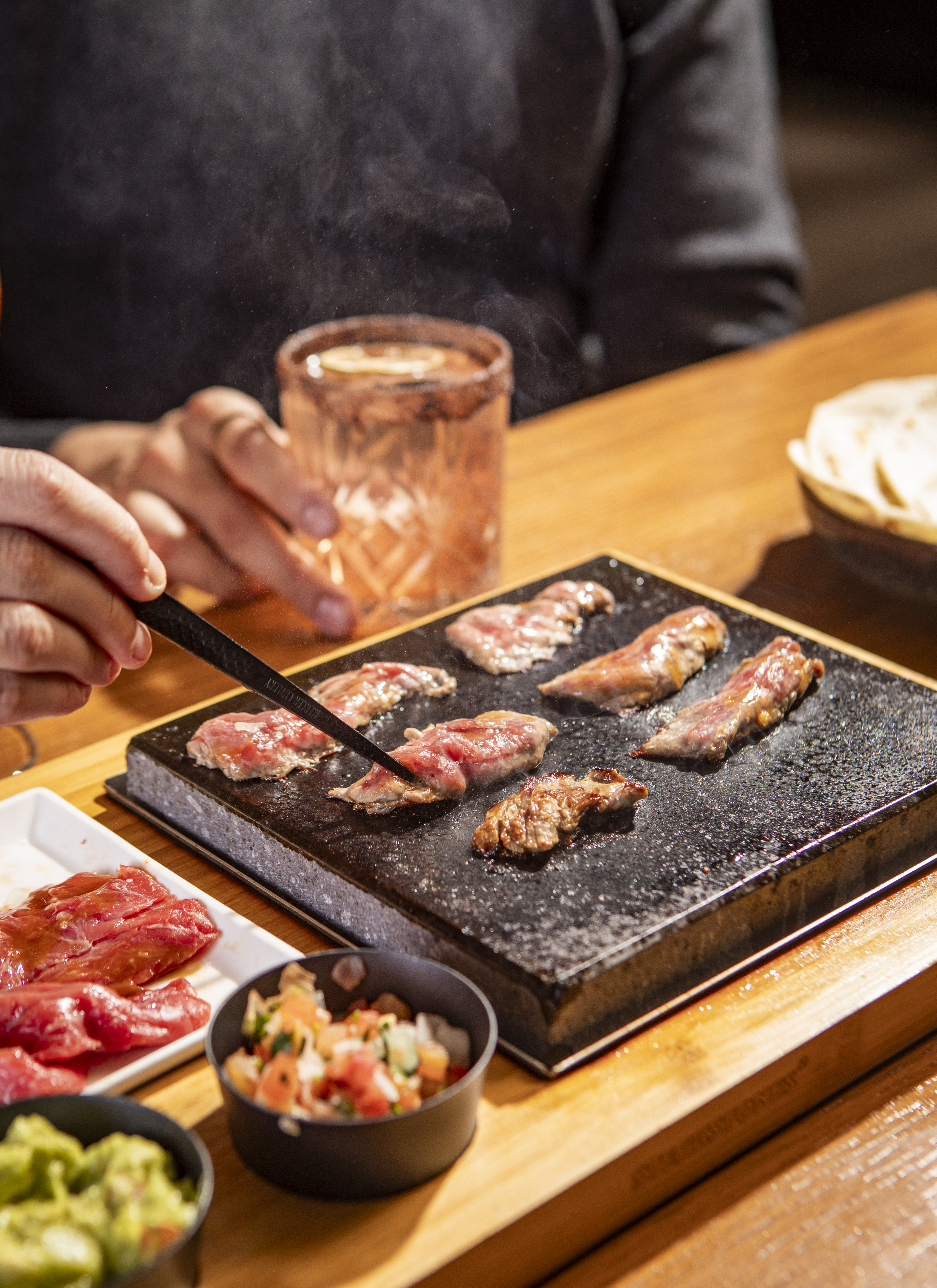 a person sitting at a table with a plate of food