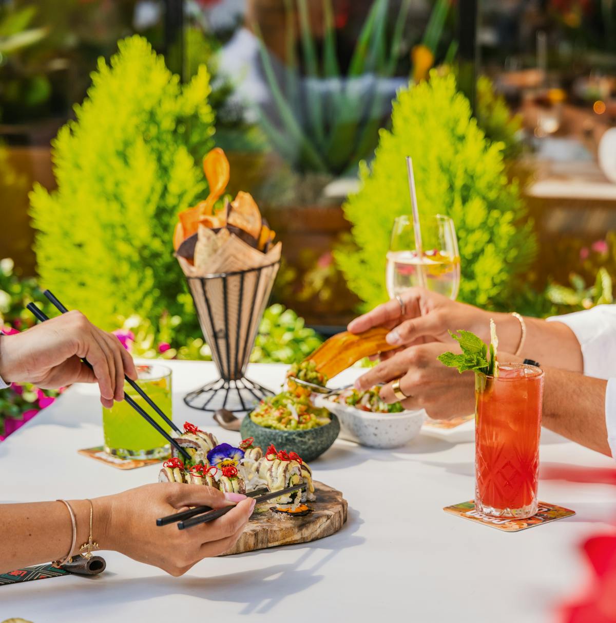 a group of people sitting at a table with a plate of food