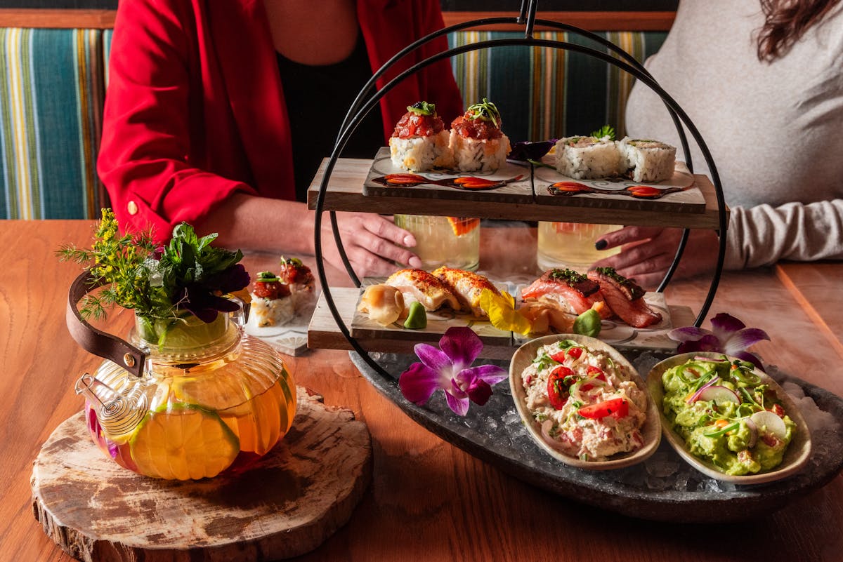 a person sitting at a table with a plate of food