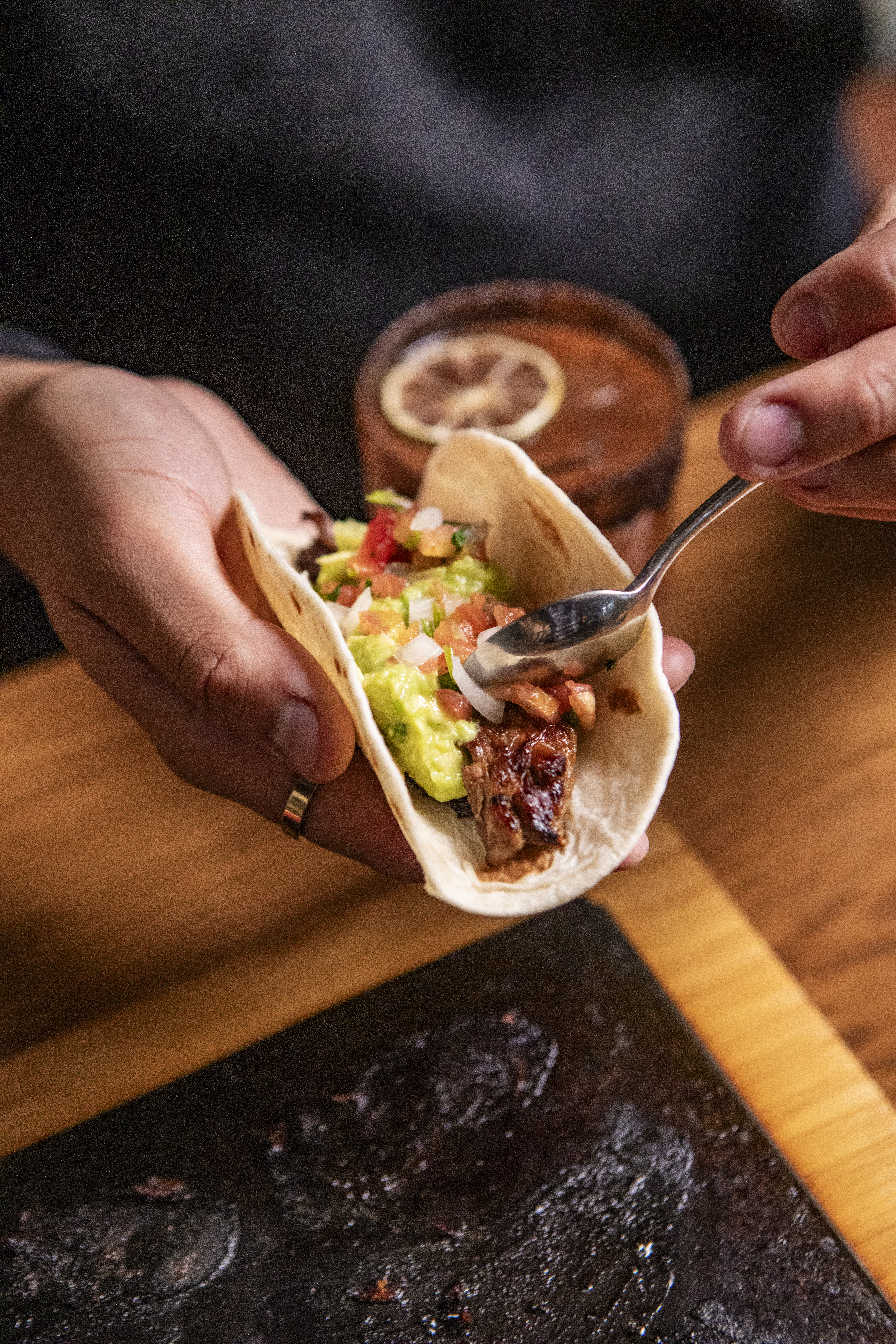 a sandwich sitting on top of a wooden cutting board