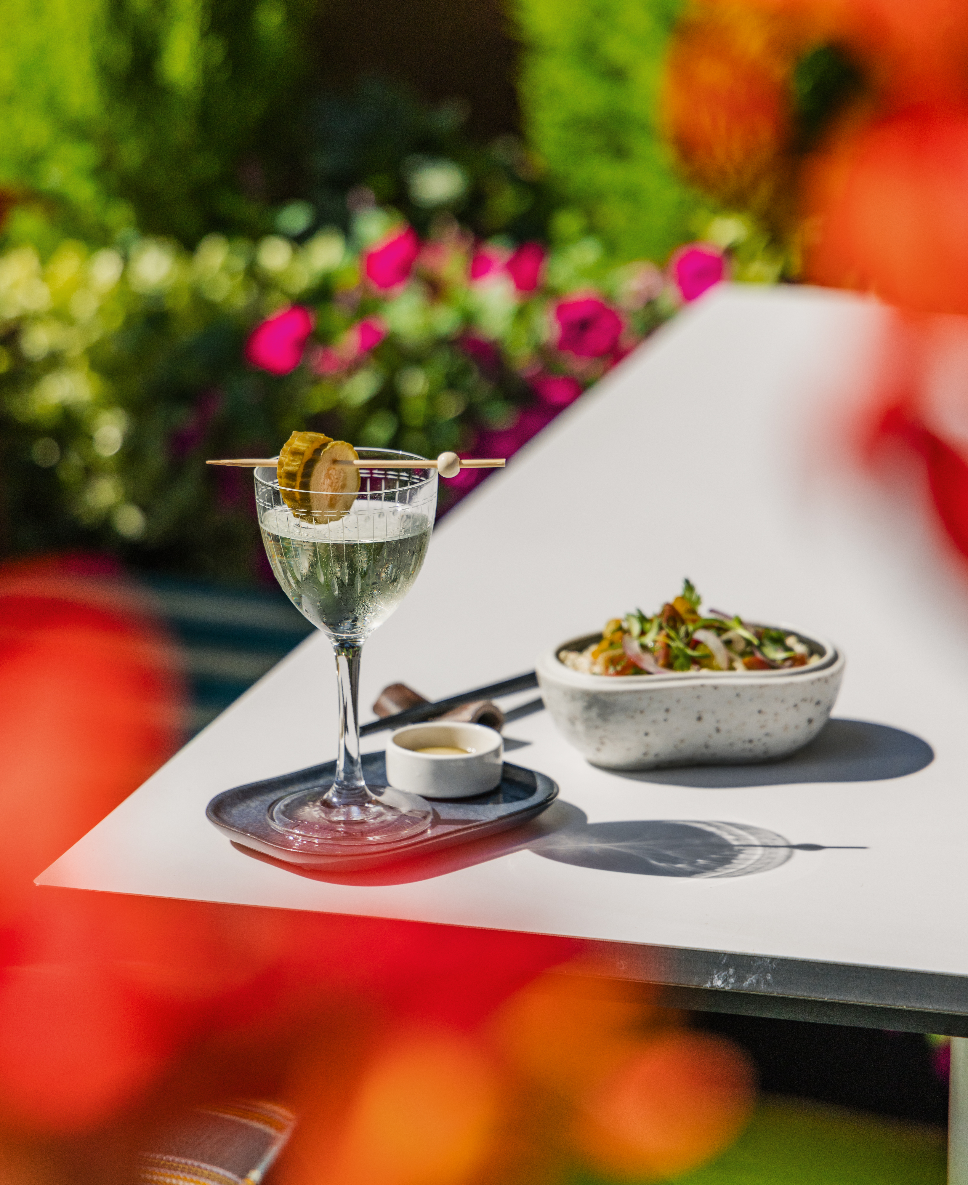 a plate topped with a vase of flowers on a table