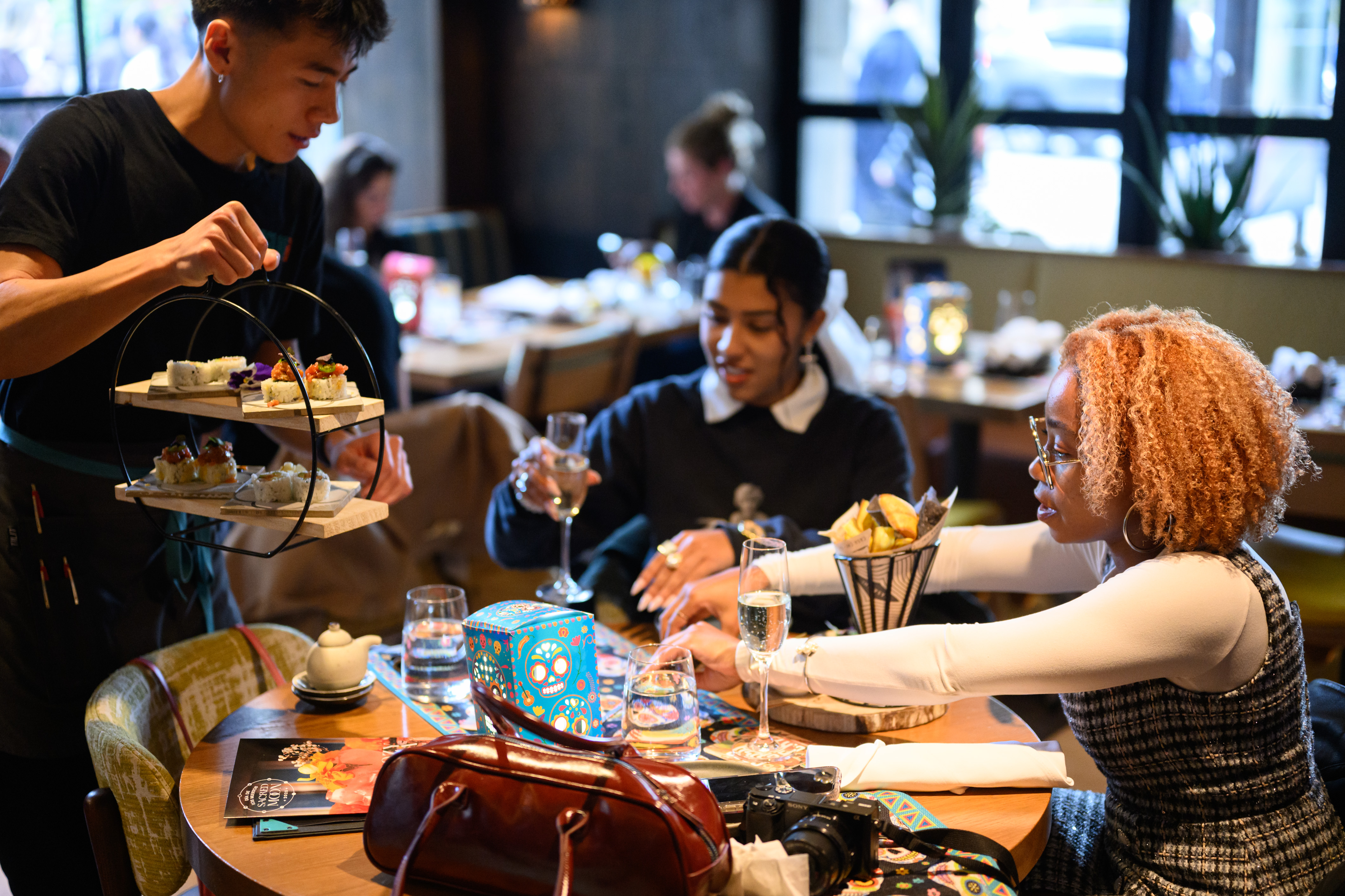 a person sitting at a table with wine glasses