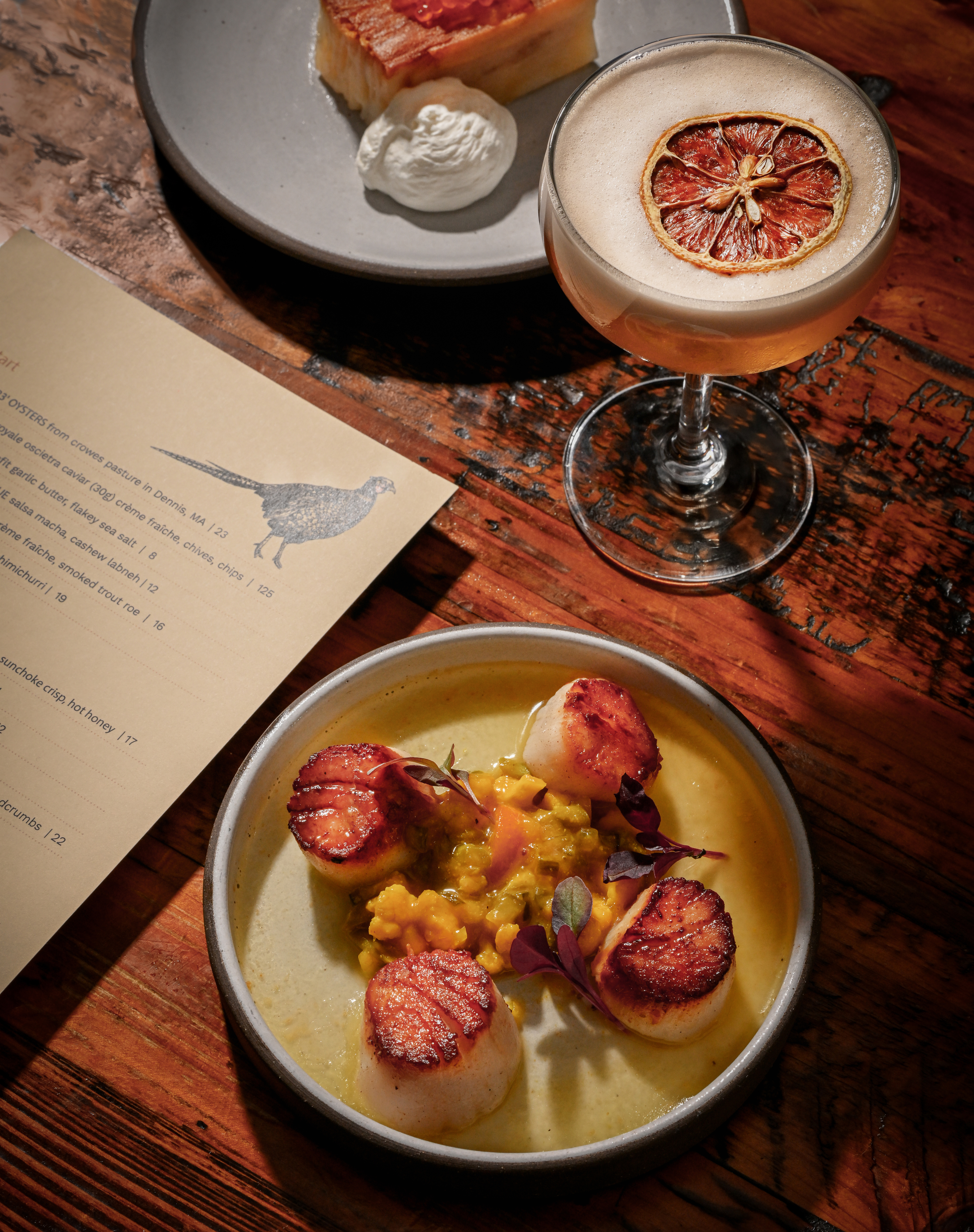 a plate of food and a drink on a table