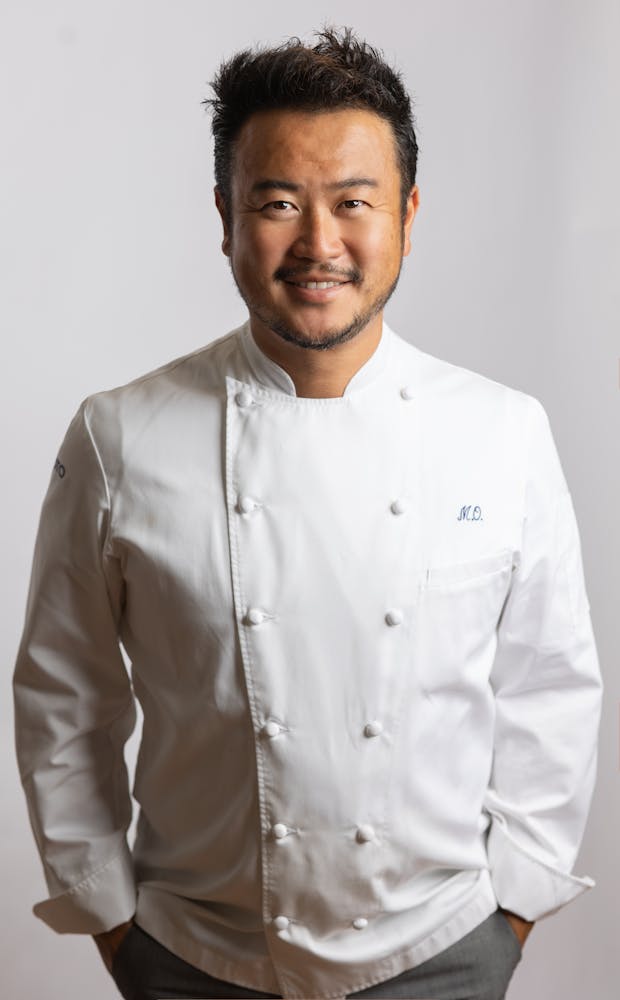 a man wearing glasses posing for the camera