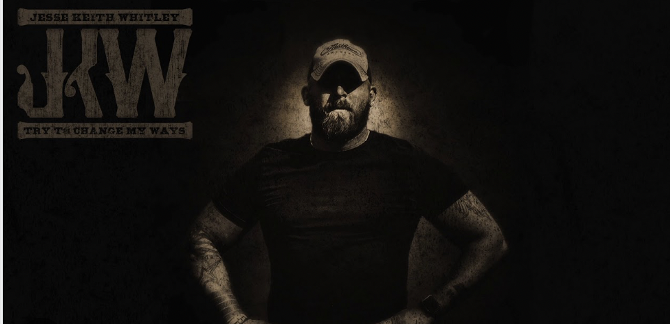 a man that is standing in the dark