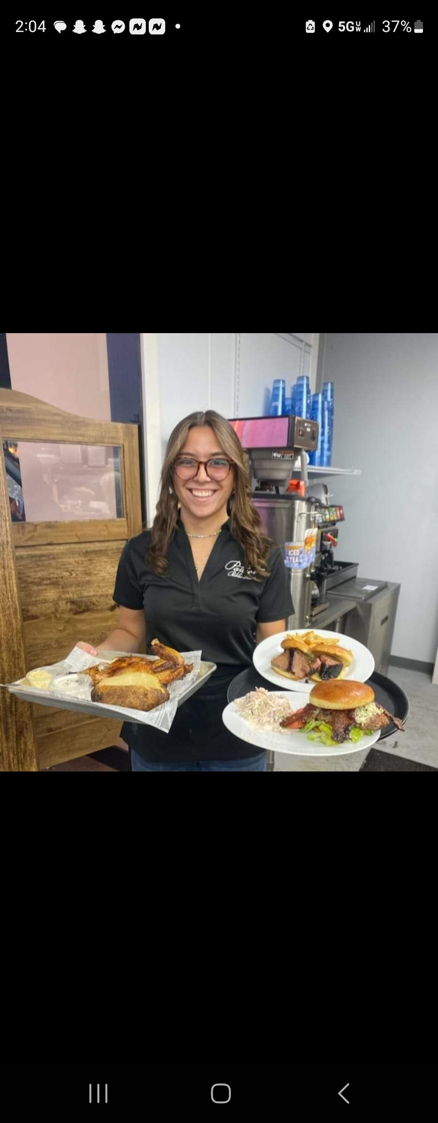 a woman sitting at a table with a plate of food