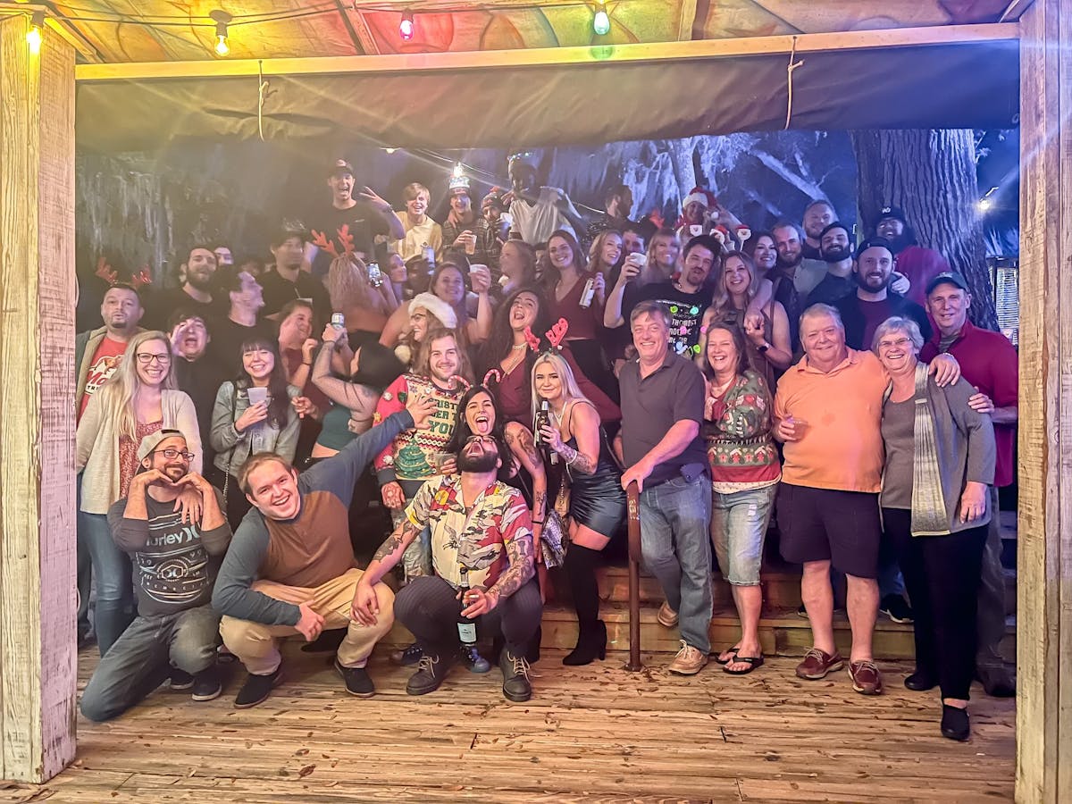 a group of people standing in front of a crowd posing for the camera