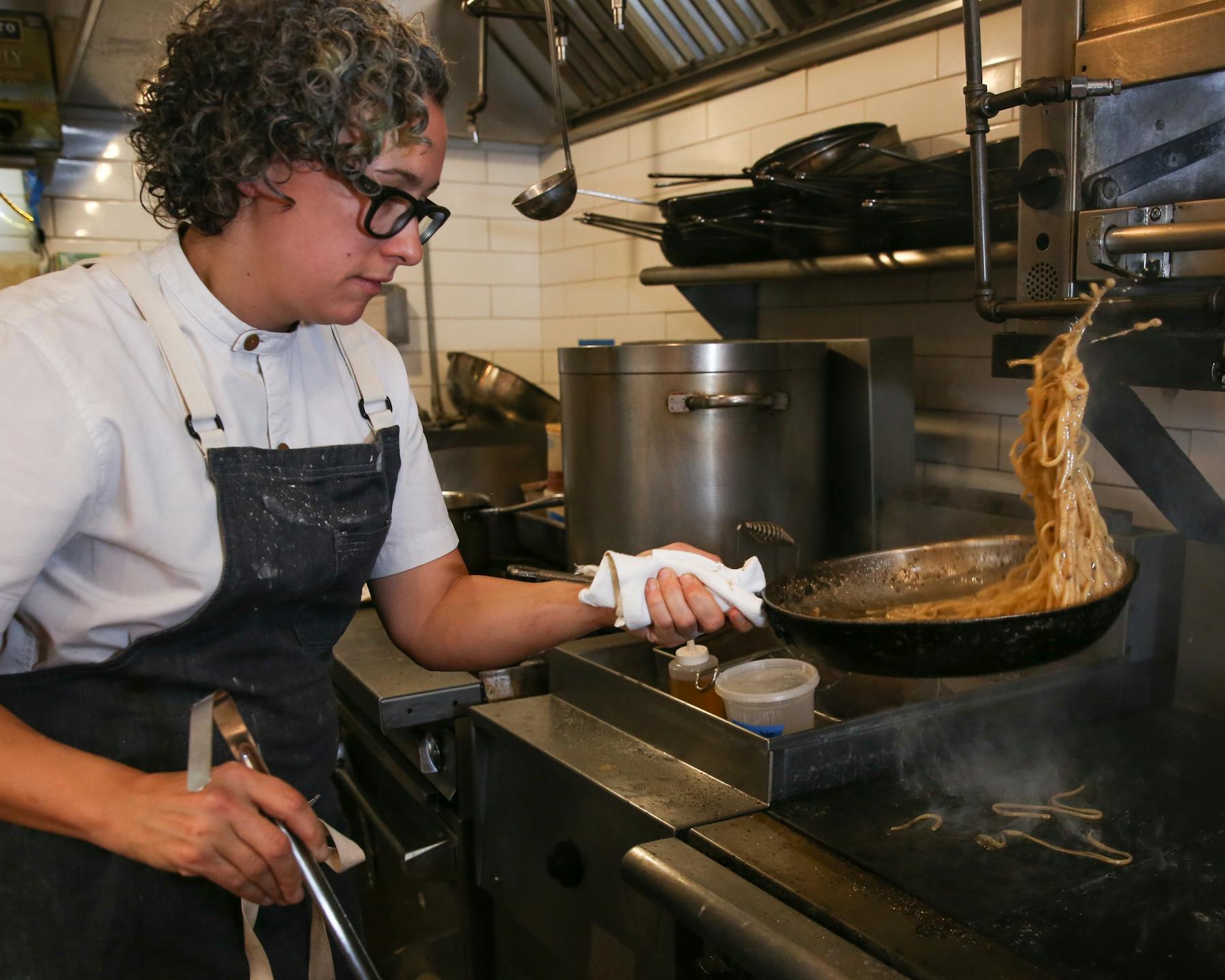 a person cooking in a kitchen preparing food