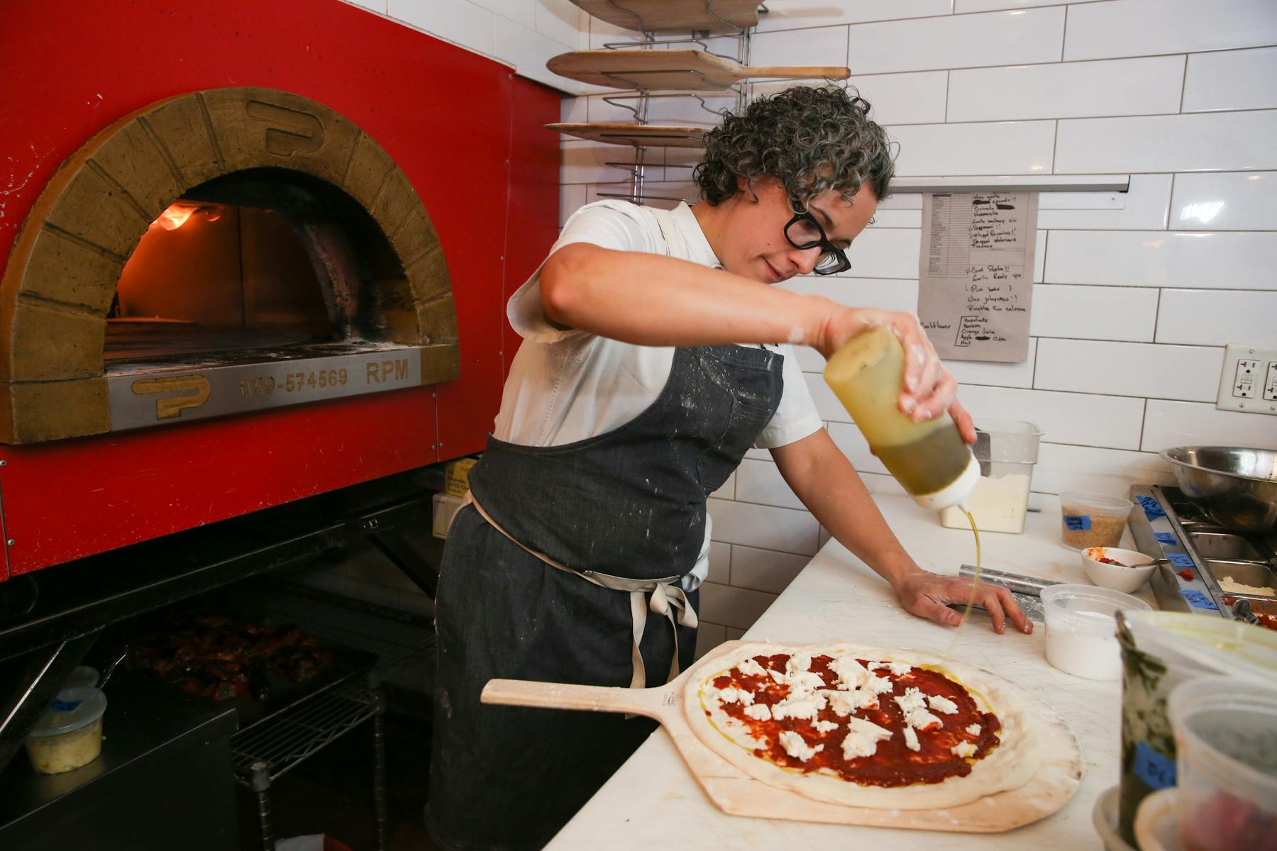 a person holding a slice of pizza