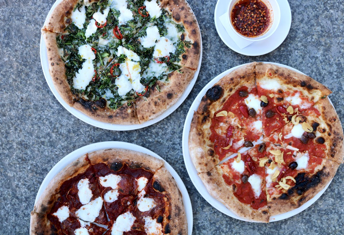 a pizza sitting on top of a plate of food