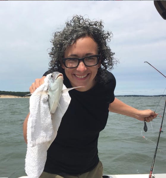 a person holding a fish in the water