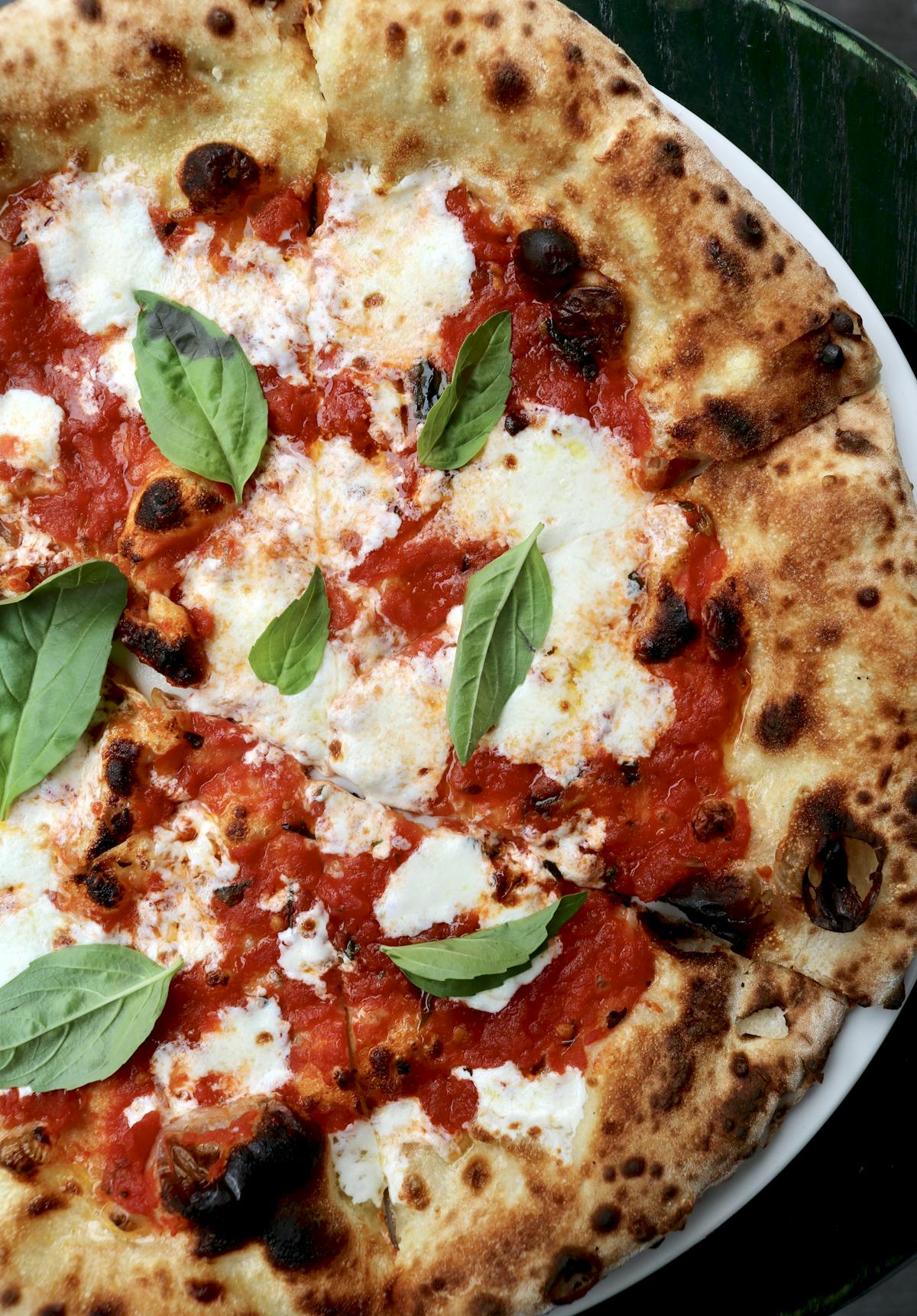 a close up of a plate of food with a slice of pizza