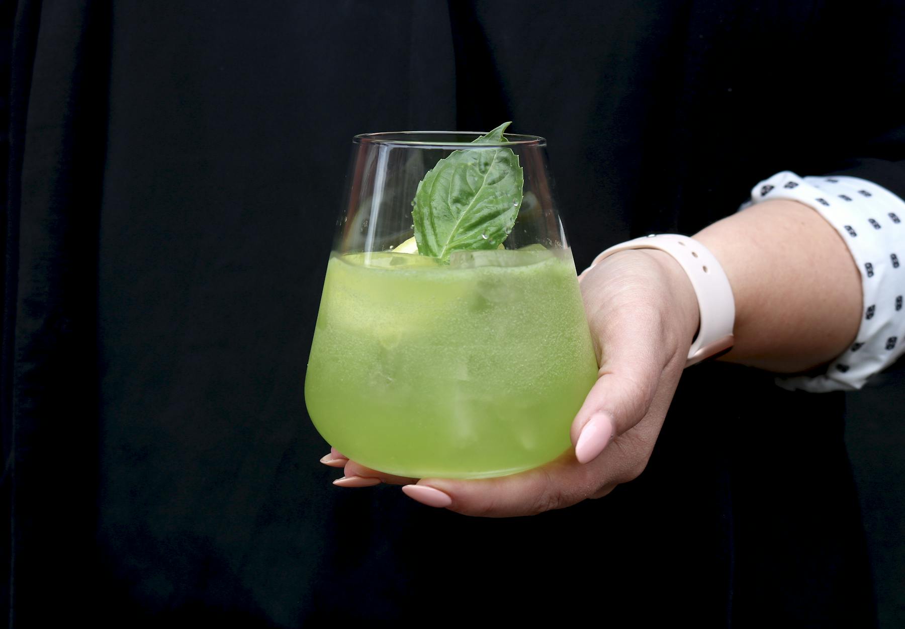 a hand holding a glass of wine