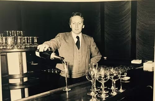 a man standing in front of a table