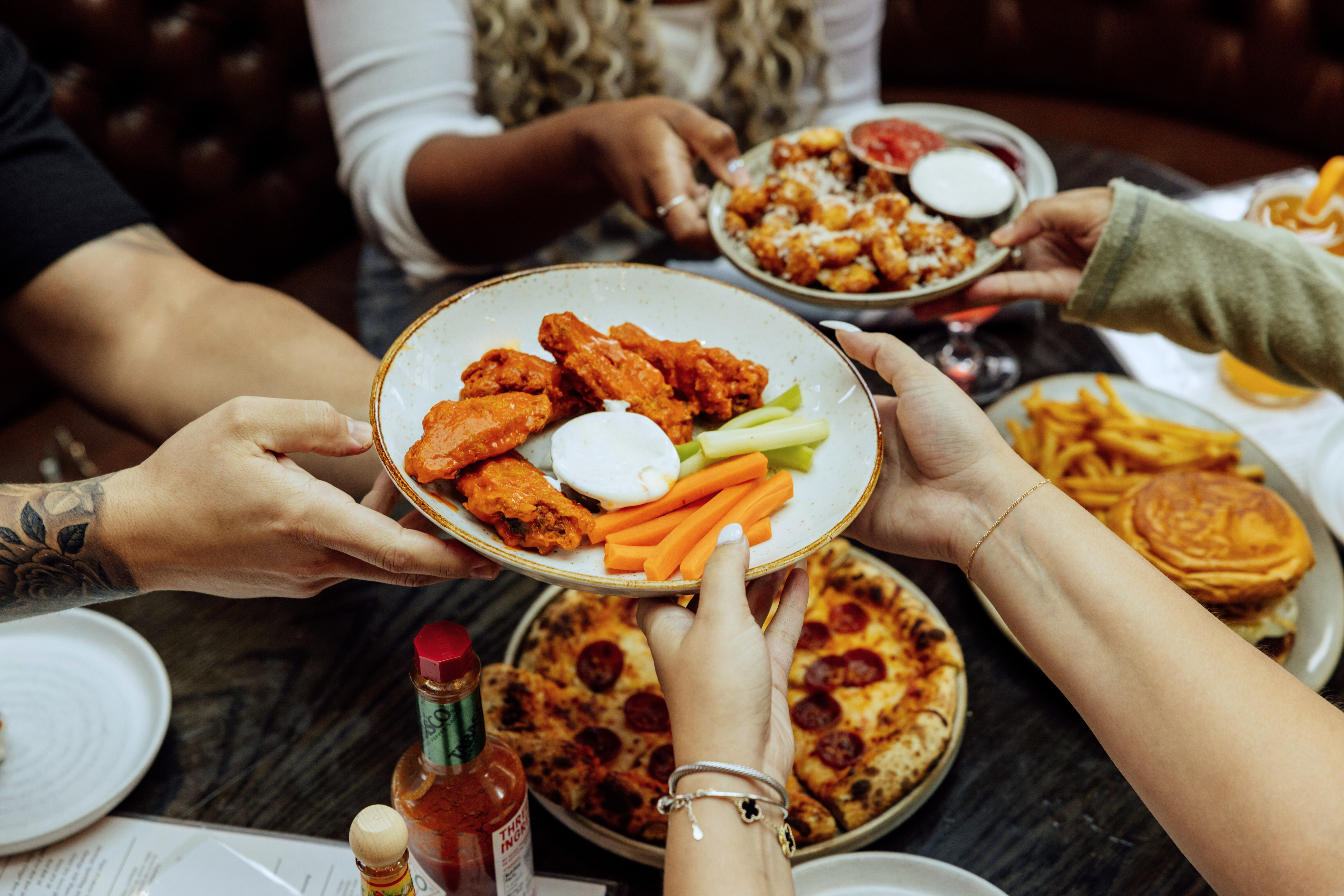 a woman sitting at a table with a plate of food