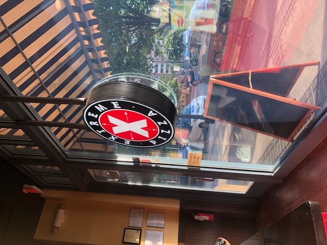 Store front window with logo hanging in the center